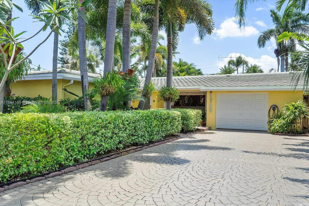 Located in the desirable Coral Heights neighborhood of Oakland Park, this home offers ultimate privacy with lush tropical landscaping and a spacious 20x20 Florida room featuring 4 sliding glass doors overlooking the large diamond-brite pool (2019) with travertine deck (2019). Recent upgrades include flat roof (2024), impact garage door (2025), impact front/back doors, accordion shutters, and PVC/pvc-lined plumbing. Other highlights: outdoor hot/cold shower, generator bypass, updated pool equipment (2023), central AC (2020), and insurance credits for protected openings. Just 1.5 miles to the beach!