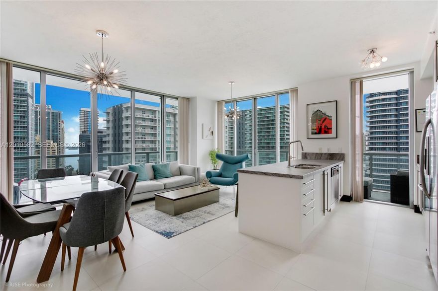 THE HOTTEST CORNER UNIT IN BRICKELL CAN BE YOURS! Best deal in the city - A rare gem, this stunning 2 bedroom & 2 bathroom unit at Axis Condominium offers breathtaking city, sea, and sunset views. Featuring custom California Closets and resurfaced kitchen and bathroom cabinets, it’s move-in ready. The wraparound balcony, accessible from the living room and both bedrooms, enhances the open feel. Enjoy top-tier amenities, including two pools, a jacuzzi, a gym, and a spacious entertainment area. With one parking space and easy access to the Metromover and Metrorail, you’re just moments from world-class dining, nightlife, Downtown, the Design District, and Miami Beach. Live the life that you deserve!