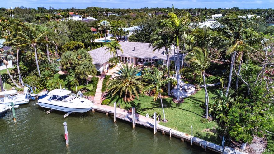 Wide water views and no bridges to Biscayne Bay. Serene waterfront home in the beautiful gated community of Old Cutler Bay, a quiet, traffic free secluded compound. This home has plenty of charm, is positioned in the nook of a cul-de-sac, and offers a sprawling tropical backyard and surrounding mature landscaping. A boater’s dream with more than 120 ft of water frontage, a boat lift and desirable prevailing SE breezes on pool, patio. Restore or build your picture-perfect home.