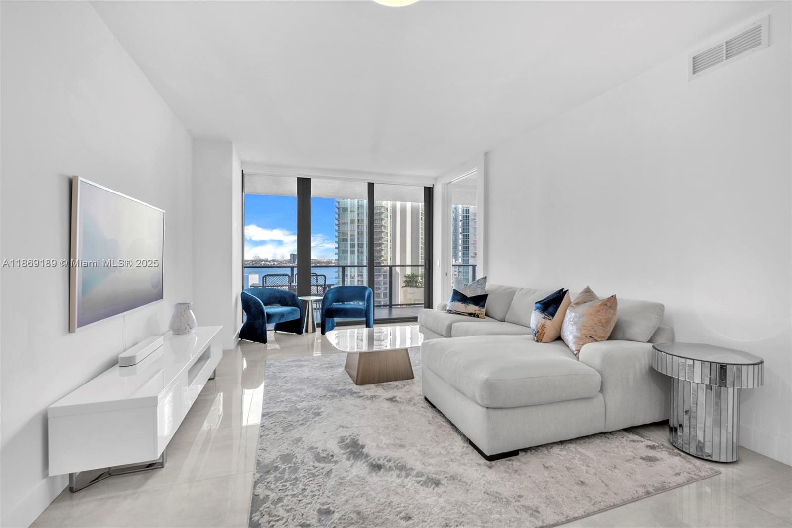 Sophisticated furnished 2-bedroom, 3-bath residence in Paraiso Bay, featuring expansive east-facing balconies with panoramic views of Biscayne Bay and the Miami Beach skyline. Private elevator entry opens to a spacious layout with sleek finishes and abundant natural light. Residents enjoy resort-style amenities including a bayfront pool, spa, state-of-the-art gym, tennis courts, social lounge, children’s playroom, landscaped gardens, and 24-hour concierge, valet, and security.