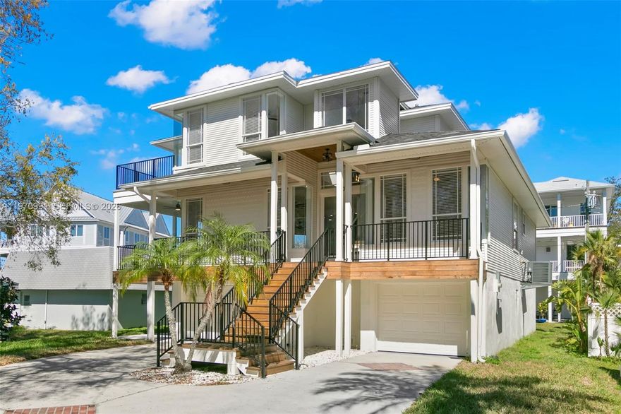 Motivated Seller! Big Price drop .. Discover coastal living at its finest in this fully renovated Key West-style retreat nestled in the heart of Crystal Beach. Located just steps from the Gulf of Mexico on the picturesque shores of St. Joseph Sound, this expansive 5-bedroom-4 bath home blends luxury, functionality, unbeatable location, outstanding sunsets, boating, biking on the Pinellas Trail and of course quiet relaxation. Step inside the 3000 square foot home to soaring ceilings, oak hardwood floors, and an open concept layout that flows seamlessly from the spacious living room to the chef inspired kitchen. Three bedrooms are located on the 2nd floor along with 2 bathrooms, another bedroom is on the first floor with its own bathroom, while your private master suite with dual walk-in closets, a spa like bath with freestanding tub, a private balcony with panoramic Gulf water Views takes over the whole Top floor. The 3-story home also includes amazing staircases and an elevator to make this home just one of a kind. Outside, relax on one of four newly rebuilt balconies, surrounded by tropical landscaping and coastal breezes. also includes a 5 car garage . Crystal Beach offers an amazing community, great schools, relaxation, paradise.  No HOA.