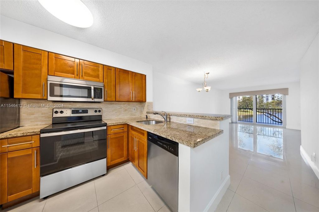 Photo of 2228 N Cypress Bend Dr #206, Pompano Beach, FL 33069 (MLS # A11546413)