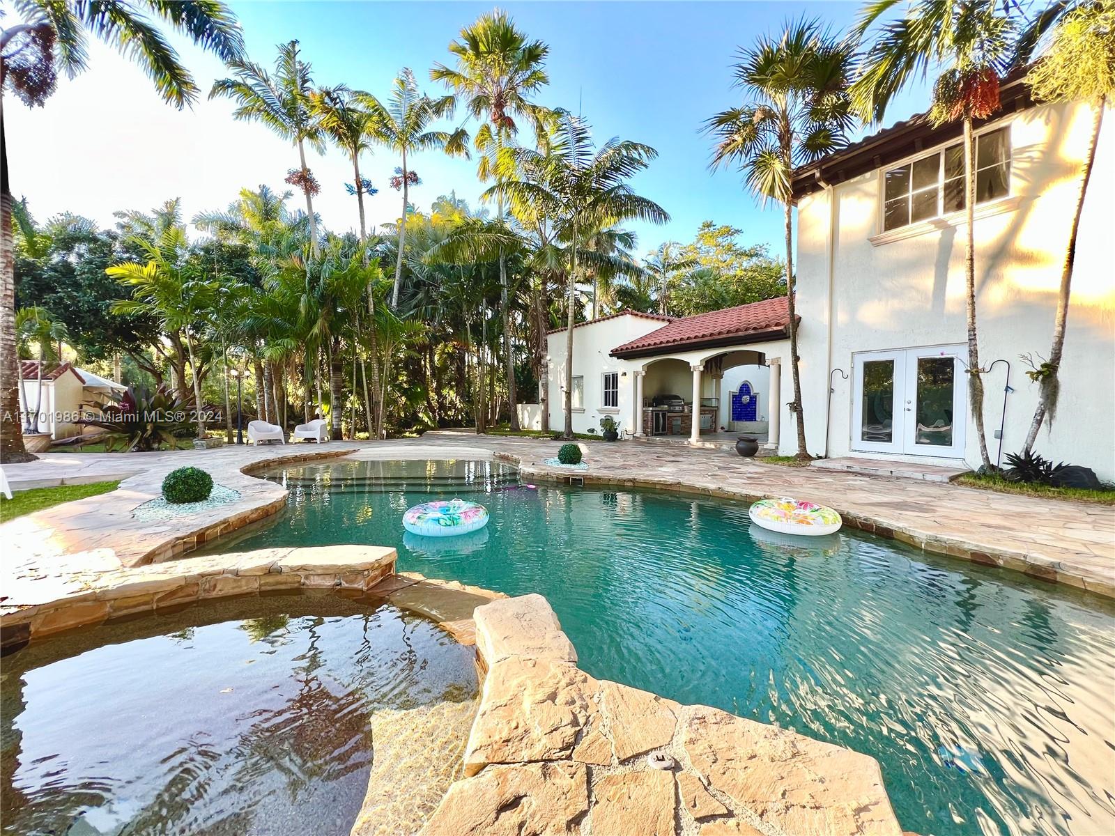 Outstanding 5-acre gated property with unmatched quality and unparalleled views. This beautiful home features 5 bedrooms, 3.5 bathrooms in the main house, 2 bedrooms, and 1 bathroom in the guest house. You must experience this 5-acre estate with its marble floors, high-end kitchen, beach-style pool, outside kitchen and bar with surround sound, huge circular driveway, electronic gate, brand new 6 horse stable , over 60k appraised in exotic palms with a running trail, koi pond, Chicago pavers and impact windows. Brand new bar built in 2022 with a/c, industrial sinks, hot and cold water, ice maker, fridges, and beer dispensers. Gorgeous waterfall with an artificial beach. The roof is from 2022. Text listing agent for appointment so showing till bank accept a offer please send your offers