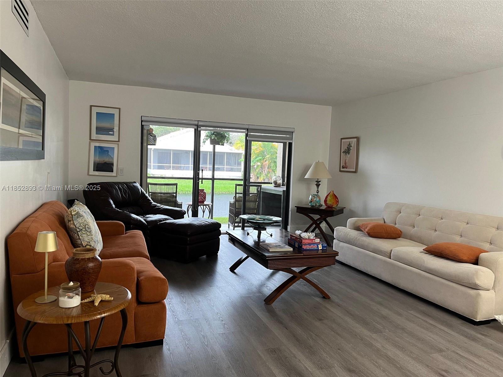 Enjoy this beautiful 2 bed 2 bath condo with a refreshing and gorgeous water view in the city of Weston. The unit is located on the first floor and features remodeled bathrooms, new granite countertops in the kitchen, laminate wood and ceramic floors, newer washer & dryer, and tankless water heater. Property has a patio overlooking a canal and accordion hurricane shutters. Parking space is conveniently located in front of the unit. Great Town Center amenities. such as: Gym, tennis, bowling, pool and much more.