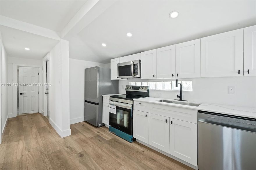 A must see!!! Cozy 2 bed/2 bath updated home w/central A/C, new kitchen cabinets with quartz countertops, SS appliances, Impact windows, new roof 2025, laundry room, tankless water heater, huge lot for creative ideas even to generate extra income. Great location in the emerging area, great investment. Close to I-95