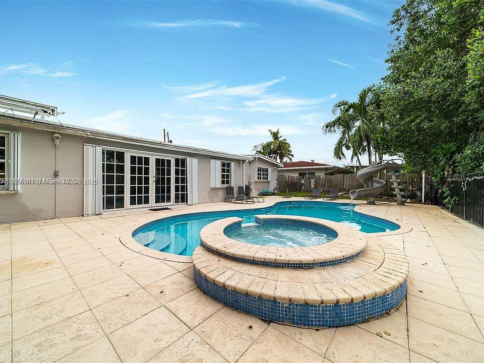 Waterfront 5-bedroom, 3-bath pool home with waterslide in sought-after Enchanted Lake! Enjoy ocean-access canals perfect for jet skis. Located in a quiet, family-friendly community with top-rated schools. Currently a successful short-term rental, offering strong income.