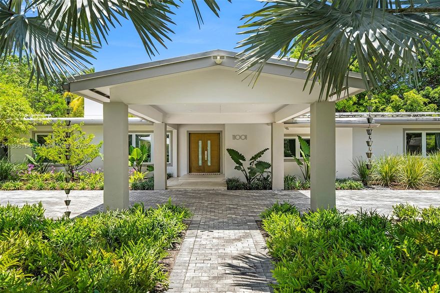 Positioned on a 34,000 SF corner lot in North Pinecrest, 11001 SW 64th Ave is a one-story 4,600 SF single-family home with 5 beds and 4 baths, currently configured as a 4-bed. The home features ceilings up to 10.5 ft, impact windows/doors, gated entry, and a covered driveway. Defining features include a renovated kitchen with high-end appliances, two distinct dining areas, a massive great room and family room with a brick fireplace, renovated baths, a large playroom, laundry, and a two-car garage. The backyard is turnkey with a heated pool, summer kitchen, dining area, and generous outdoor living space. Upgrades include an ENERGY STAR-rated cool roof for reduced cooling bills, a 10.8 KW solar array with the option to double capacity, and a 120-gal on-demand solar hot water system.