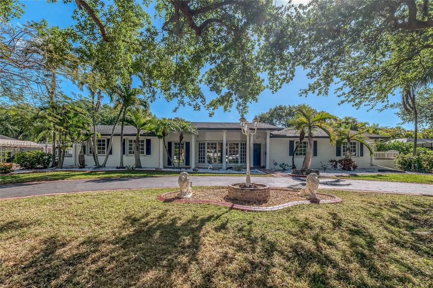 Beautifully kept and maintained, 3 bedroom, 2 bath home in the Village of Palmetto Bay. Spacious formal living and dining rooms. Kitchen has granite countertops, charming exposed brick and plentiful cabinetry, pantry and breakfast nook. Wonderful family room with fireplace. Indoor laundry room w/ sink. Lovely tropically landscaped backyard with sprawling lawn, screened patio and additional deck. Gated side yard with room to park a boat. Circular driveway. 2 car side entry garage.