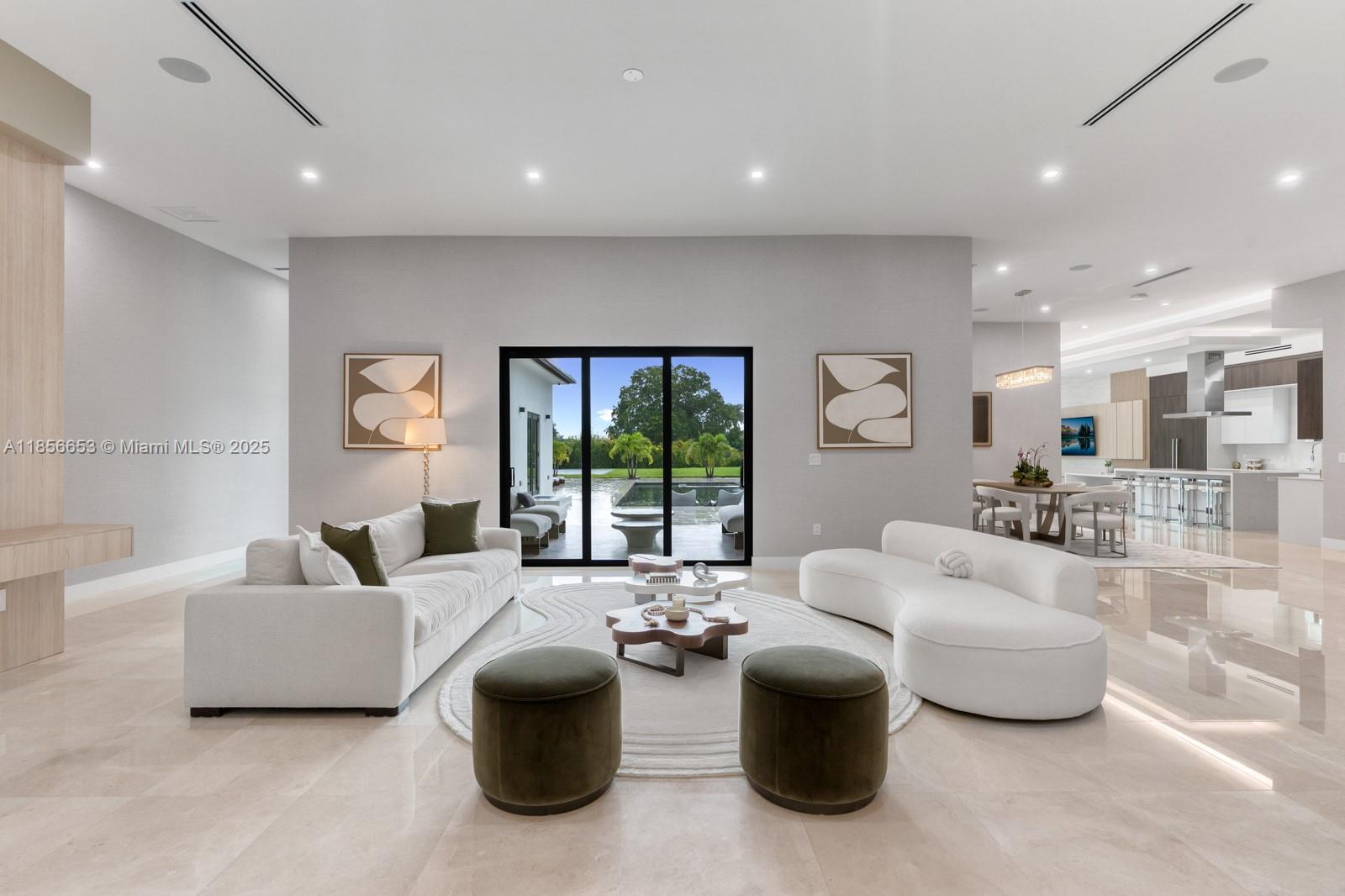 A true architectural masterpiece—this one-of-a-kind ultra-luxury estate redefines sophistication with over $500K in bespoke upgrades, curated with uncompromising attention to detail. Nestled on a 35,000+ SF gated lot, this new construction smart home spans 6,447 SF with soaring 12' ceilings, 6 bedrooms, 5.5 baths, and dramatic open living spaces. Masterfully designed for both lavish entertaining and everyday elegance. Gourmet kitchen with 10-seat marble island, custom oversized pantry, and integrated automation throughout. Resort-style outdoor living with sleek pool, integrated spa, with state-of-the-art heater automation system, covered lounge, NBA-style half court, and a detached guest house with full bath. 12-car gated motor court, offering security and
privacy.