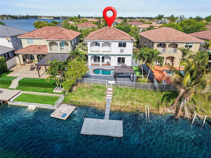 Discover lakefront living in the gated Venezia Lakes community in Miami! This immaculately updated 4-bedroom, 2.5-bath home features a dramatic entryway with sky high ceilings, stunning updated light fixtures & floors, a modern expanded kitchen, and renovated bathrooms. Enjoy seamless indoor-outdoor living with a private pool, floating dock, and direct lake access- perfect for boating and motorized watercraft! The spacious primary suite is an incredible retreat; the room is oversized with a large bathroom suite, stunning lake view & a large private balcony overlooking the pool and serene lake. Take in breathtaking sunset views each evening from your own backyard oasis. A rare opportunity to own a move-in-ready waterfront retreat in a secure, sought-after neighborhood. Call today for more!