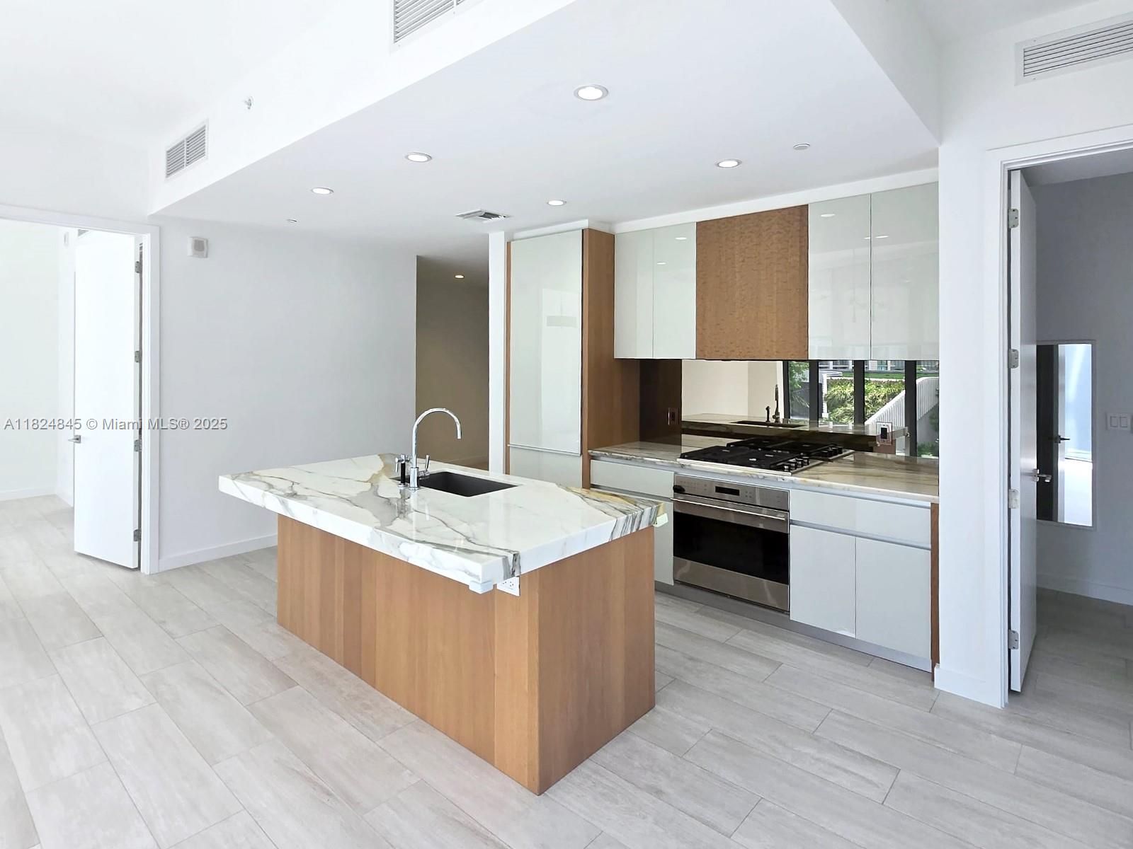Just Listed in Coconut Grove! This elegant 2-bedroom + den, 2-bathroom home boasts sweeping city views through dramatic floor-to-ceiling windows, soaring 10-foot ceilings, sleek porcelain floors, and a chef-inspired kitchen outfitted with premium Italkraft cabinetry, a spacious island, and top-tier Wolf & Sub-Zero appliances. Designed for the ultimate lifestyle, enjoy access to over 50,000 sq ft of world-class amenities: multiple rooftop and resort-style pools, an exclusive on-site restaurant, full-service spa with treatment rooms, a modern fitness center, private theater, business lounge, lush gardens with BBQ areas, kids' playroom, and more.