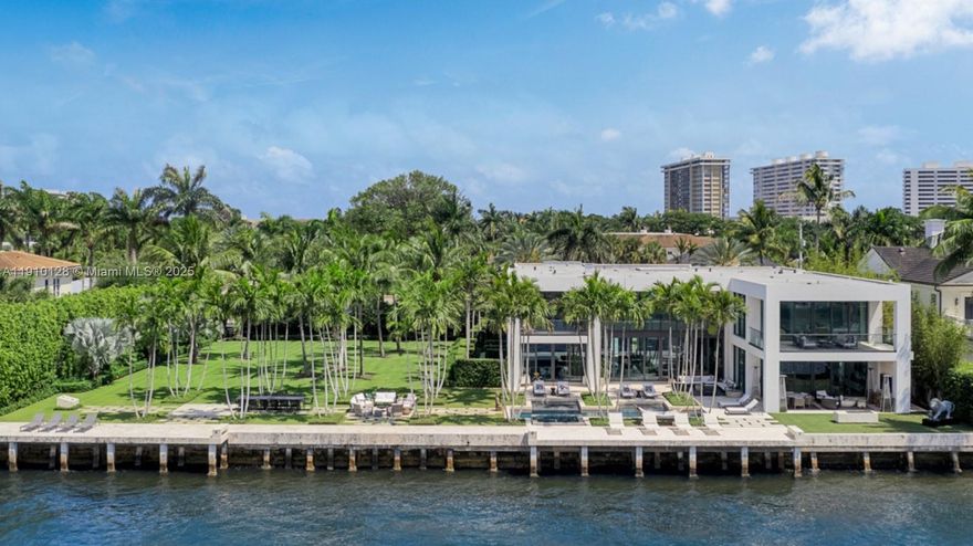 Intracoastal Estate on Boca Raton’s coveted Spanish River Road. Set on a double lot with 200 feet of direct Intracoastal frontage, this 11,245-square-foot residence (8,519 SF under air) embodies modern coastal luxury. Constructed by JH Norman with architecture by George Brewer, the home showcases walls of glass, natural stone, and warm wood tones frame sweeping water views and connect seamlessly to tropical gardens, expansive terraces, and a resort-style pool. Designed for both grand entertaining and private retreat, the residence showcases panoramic water views, refined elegance, and complete privacy. A true architectural statement, it captures the essence of sophisticated, sun-soaked South Florida living.