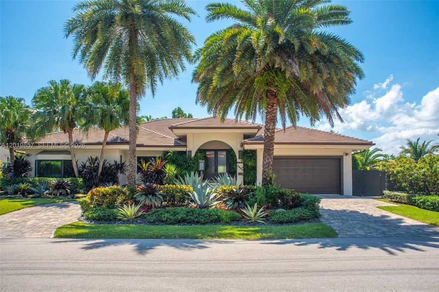 This stunning one-story custom-built home is a dream come true for yacht owners, offering 50ft of waterfront property. The home boasts high ceilings. Perfect for boat enthusiasts. Professionally decorated with the finest quality finishes throughout, including custom-built wall units, impact windows and doors, wood plank floors, and a newer flat tile roof. The home features a built-in bar, a huge great room, and a newer remodeled spacious eat-in kitchen with marble countertops and backsplash, a Miele gas stove, Miele oven, microwave, espresso, and wine cooler, built-in Subzero refrigerator and freezer, tall cabinets, and pull-out pantries. A must see opportunity.