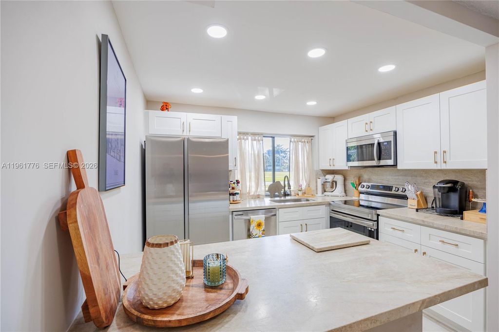 Photo of 9100 Lime Bay Blvd #111, Tamarac, FL 33321 (MLS # A11961776)