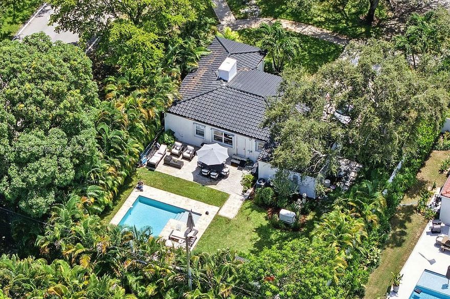 Your Private Oasis in the Heart of Miami Shores. Set on an expansive 9,225 sq ft corner lot, this designer-updated 3-bed, 2-bath residence delivers the kind of outdoor living Miami is known for. Mature tropical landscaping, a Gunite pool with and sun shelf, and complete privacy fencing turn the property into a resort-style sanctuary. The upgraded kitchen has quartz countertops, stainless steel appliances, and a smart washer/dryer. A full-home generator, new privacy fence, and a brand-new Trane HVAC system with Nest controls ensure comfort and security year-round. Perfect for both quiet relaxation and memorable entertaining, this home offers a lifestyle that is increasingly hard to find at this price point in Miami Shores.