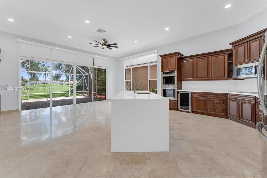 Beautiful Home in Highly desirable Bay Isle Neighborhood of Weston Hills Country Club Golf Community! This stunning property offers 3 spacious bedrooms plus an office or 4th Bedroom. Double Glass Entry doors. Stunning Golf course Views.Fully remodeled Kitchen, Marble floors, Crown Molding and Plantation Shutters. Large Master Suite overlooking golf course! Large custom walk in closets. Gourmet Kitchen, Top of the line Stainless Steel Appliances. Wine Cooler, Granite countertop. Large Screened patio. Surrounded by top rated A+ schools