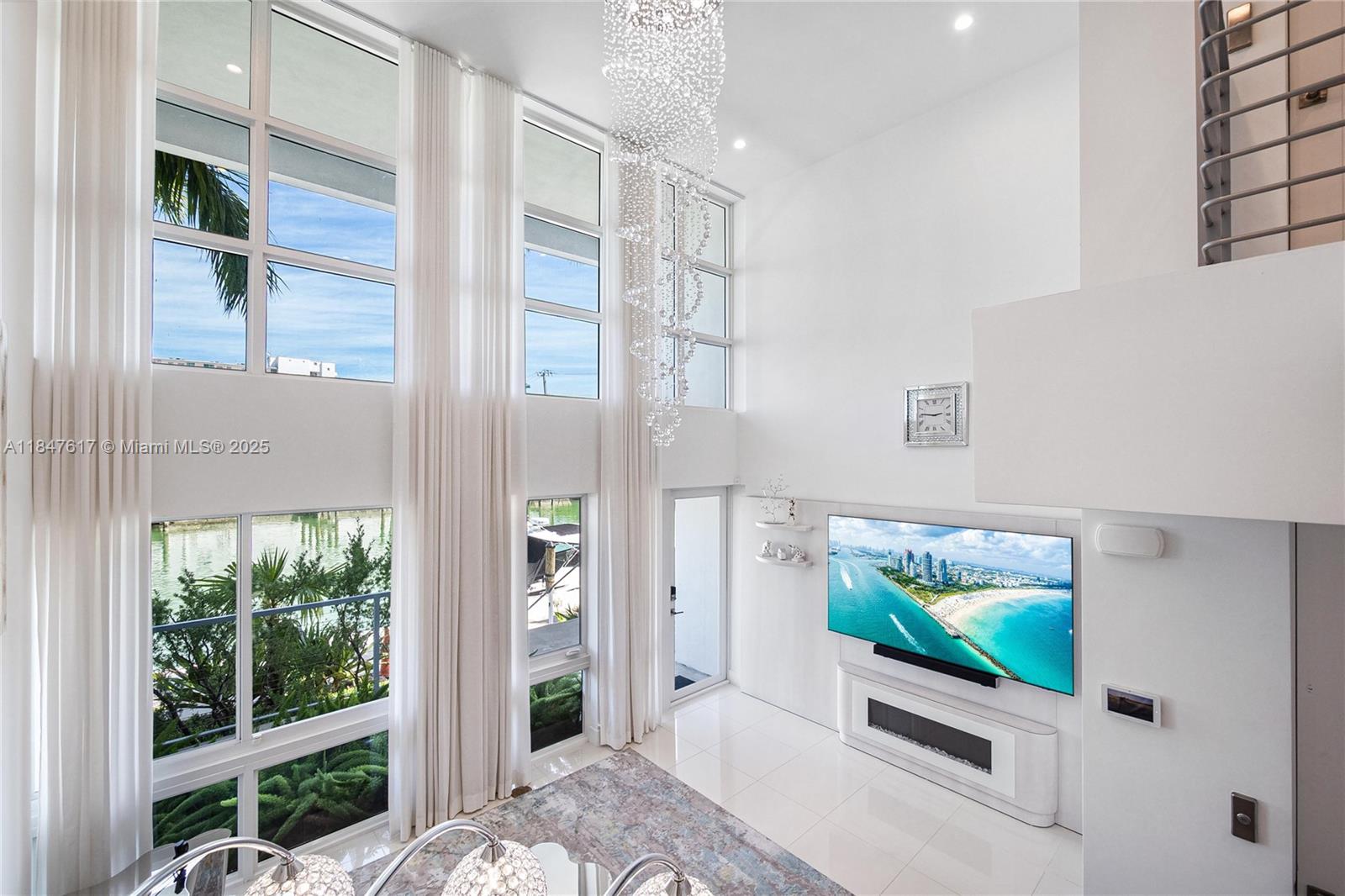 IRIS ON THE BAY. Experience the best of modern waterfront living in this spectacular townhome, perfectly nestled in the exclusive gated community on Normandy Shores Island, Miami Beach. This one-of-a-kind residence captivates with panoramic water views, soaring 18-ft ceilings, sleek gourmet kitchen, custom cabinetry, gas range. Spanning 2,646 sq. ft. across 4 luxurious levels, this home features a private elevator, expansive waterfront terraces?, impact windows and doors, custom closets, and a spacious garage.
Ideally located across from Fairway Park, you'll enjoy direct access to tennis courts, a golf course, basketball courts. Walk to the beach, dine at nearby restaurants, and soak in the Miami lifestyle.
If you're seeking your dream home, look no further! Dock space available!