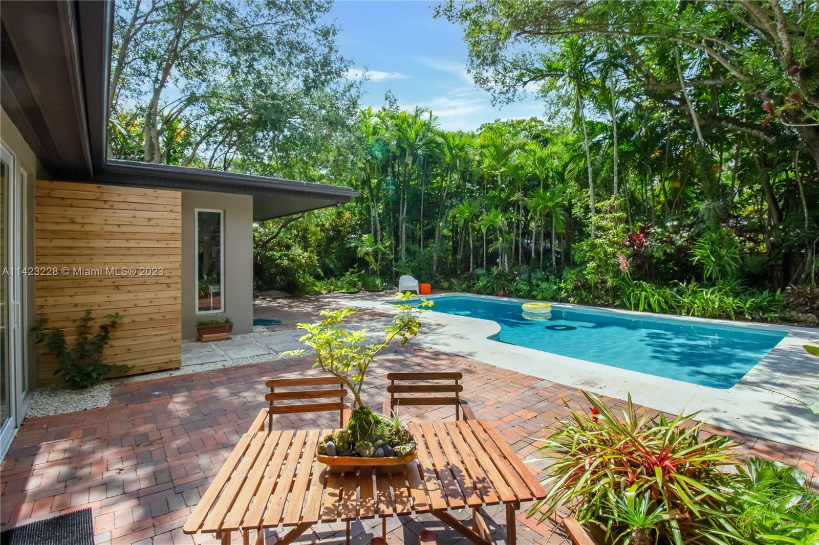 Discover this cool home nestled among towering trees and a variety of flowers and plants. This remarkable 2bed/2bath home, includes an outdoor shower as part of one of the bathrooms. It also offers a refreshing pool and an area that could be an inspiring workshop that invites you to unleash your creativity. Imagine waking up and stepping out of your suite to jump into the pool or enjoy the serene surroundings. Conveniently located in a very quiet street with a gorgeous canopy in South Miami, and just minutes away from Downtown SOMI, Metrorail, South Miami Hospital, UM, US1 and more. Experience the charm of an up-and-coming neighborhood with new constructions and remodeled homes, and picturesque streets for walking, biking and enjoying the outdoors.