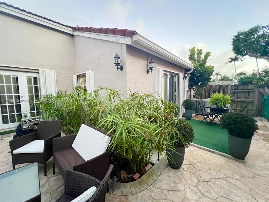 Beautiful one-story home @ Las Casas, Gated community. Featuring two spacious bedrooms and 2.5 bathrooms, open floor plan /vaulted ceilings that create a bright and airy atmosphere. The remodeled kitchen includes stainless steel appliances and granite countertops, with a convenient snack counter that opens to a great room. Large great room that opens to a private paved backyard, ideal for entertainment or quiet enjoinment. The master bedroom comes with a walk-in closet for added storage. Accordion hurricane shutters throughout the house. Situated in a small, exclusive community of 44 homes, Great location for proximity to A+schools, shopping, etc.