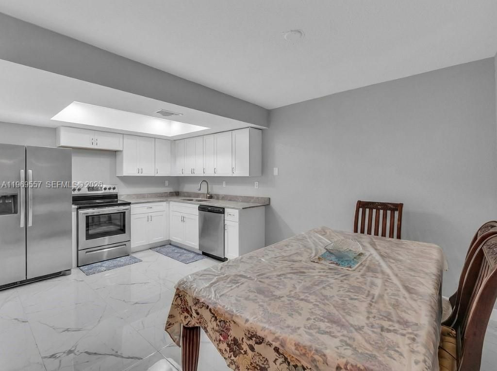 Photo of 34 Meacham Ln, Tamarac, FL 33319 (MLS # A11969557)