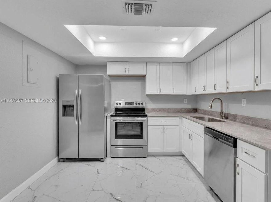 Amazing Fully Remodeled Townhome In The Heart Of Tamarac! BRAND NEW KITCHEN JUST INSTALLED!  New Large Tile Downstairs, Knock Down Textured Walls, Recessed Lighting And Half Bath Downstairs. 2 Upstairs Bedrooms Have En-Suite Bathrooms. Wood Flooring On The Stairs And Second Story. The Large Primary Suite Has A Walk-In Closet, And A Huge Balcony overlooking the canal. The Remodeled En-Suite Bathroom Has A Tub, White Vanity And Toilet. Second Primary Bedroom Has A Walk-In Closet And Ceiling Fan. The Second En-Suite Remodeled Bathroom Has A Shower, Tile On Walls, White Vanity And Toilet. Large Screened Patio With Extra Storage. Close To Major Highways, Restaurants And Shopping. A Must See!!