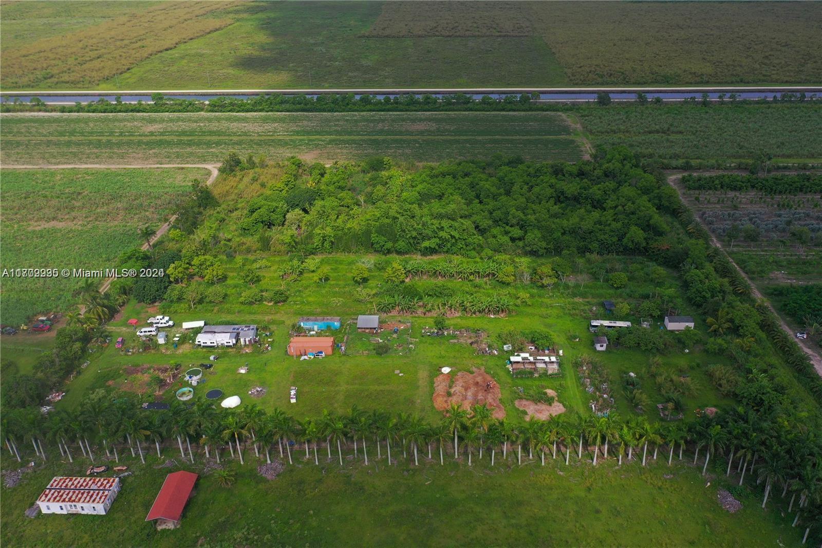 Beautiful 5.09 acres at the Redland you could build your Dream Home or create your farm. Land is Clean and has a mixed of fruit tree, fully fenced has 2 shipping container small mobile home and well water there is a nature preserve on the south side located in a primary agricultural area close to the everglades. Located 5 min off paved road most drive 5 min through the dirt road from 217 ave.