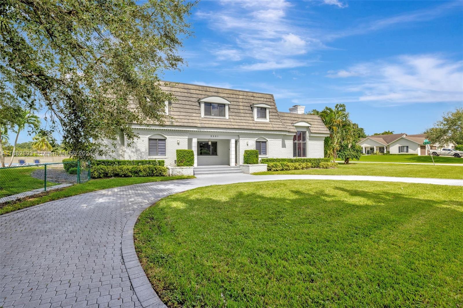 Discover a charming Cape Cod-style home with Contemporary Flair. Nestled on a quiet cul de sac, enjoy beautifully updated interior featuring open spaces, high ceilings and sleek finishes. Property highlights include an enclosed modern glass bar, dedicated theater room, chef's kitchen, primary bedroom with dry bar, and home elevator for comfort and ease. The expansive outdoor area boasts a sparkling pool, private tennis court that doubles as a basketball court and a gazebo seating area made perfectly for entertaining. With breathtaking lake views and a private dock, you can enjoy water cycling and kayaking right at your doorstep.