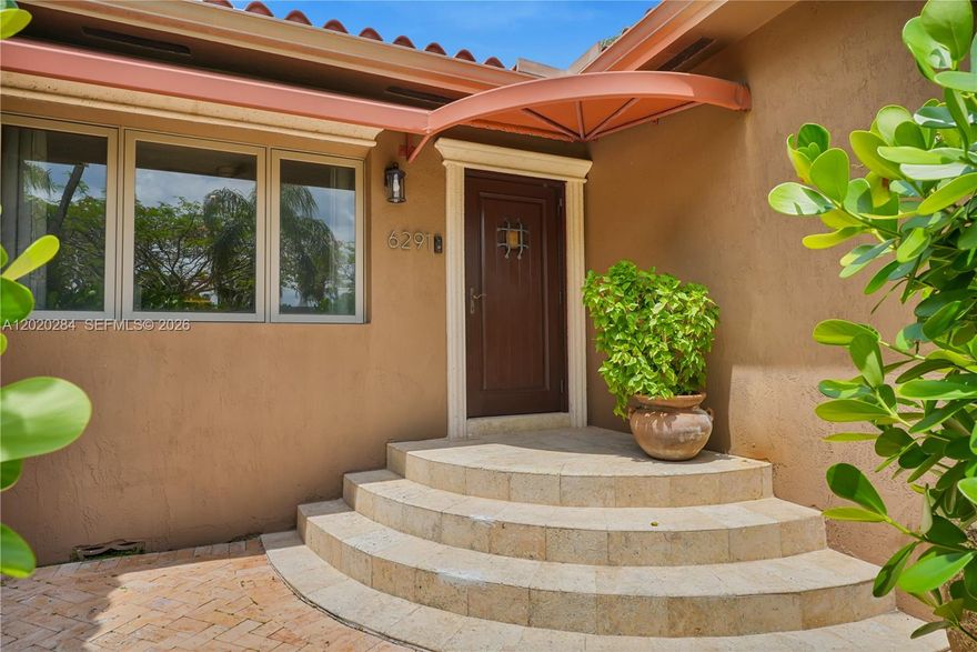 Beautifully updated 4-bedroom, 3-bath home tucked beneath Biltmore Height"s lush tropical canopy in one of Miami’s most charming tree-lined neighborhoods. Features include an newly renovated kitchen and designer bathrooms, impact windows and doors, updated plumbing and electrical, new HVAC, wood floors, and spacious light-filled living areas. Enjoy the second story master suite with a private bath, oversized walk in closet, and private balcony over looking your private tropical oasis with multiple outdoor entertaining spaces, including a private courtyard-style patio, expansive wood deck, and serene balcony views surrounded by mature landscaping.