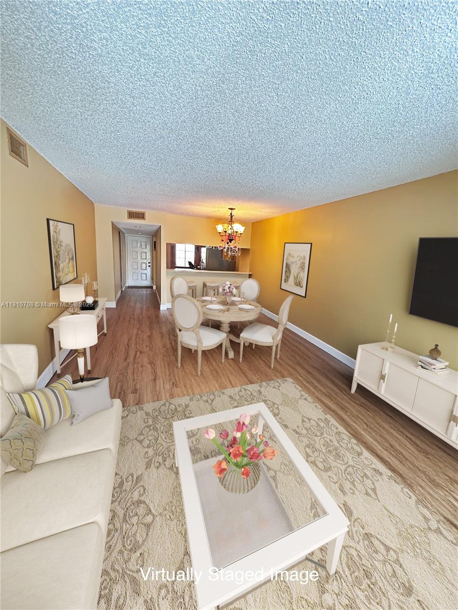 Indulge in beautiful lake views from the moment you enter this beautifully remodeled first floor unit. Freshly painted with new LVP flooring throughout, this unit is move-in ready. Wood cabinets, pristine Quartz countertops, and new appliances shine in this kitchen. Unwind in the afternoons in your back porch with warm sunsets and the lake at your footsteps. The split-floor plan offers plenty of privacy while the open concept living areas are inviting for large gatherings. New washer and dryer inside your unit. The main bedroom has 2 walk-in closets and an ensuite. Both bathrooms are designed with craft sinks, Quartz countertops, and new light fixtures. 1 assigned parking space, and plenty of visitors. New Hurricane Shutters in all windows. Close to the Turnpike and Sawgrass Mall.