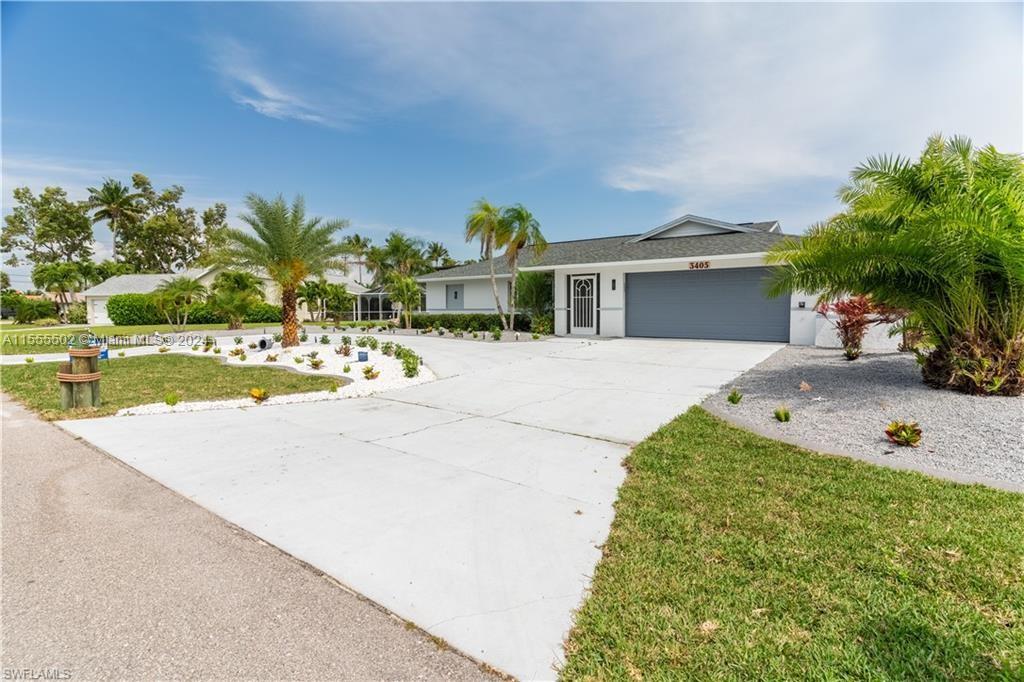 Direct Gulf Access waterfront single family house in this exclusive Palaco Grande Development. This triple lot, 120 feet of concrete seawall with a deep water canal can accommodate large boats, sailboats and yachts (no bridge). Fishing is fun right from your own dock. Electricity and water right at the dock for those mariners who will live or sleep on their boat or just need to service it. This open floor plan 3/2 house has been updated to please the most fussiest buyers. Lounge in your resurfaced gunite concrete pool, enclosed by an updated Lanai with a color changing LED Pool light and entertain your guests at your eat-in and outside countertop.