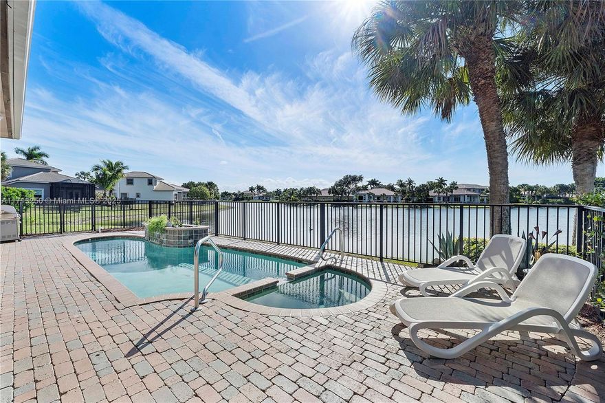 This exceptional 3bed waterfront home(3rd bed is an impressive custom office room, easy to convert back)offers stunning lake views & ultimate privacy. Situated on a large cul-de-sac lot, the property features a heated saltwater pool & an expansive sun-filled screened patio—perfect for relaxing or entertaining. The home’s open layout fills the space with natural light & creates a seamless flow from the gourmet kitchen with granite countertops, all with peaceful water views. The home is impeccably maintained w crema marble flooring, volume ceilings & ceiling speakers. Located in a secure gated community offering a safe & secure environment for enjoying a stroll along the expansive boardwalk with resort-style amenities, top-rated schools & convenient access to shops, restaurants & expressways