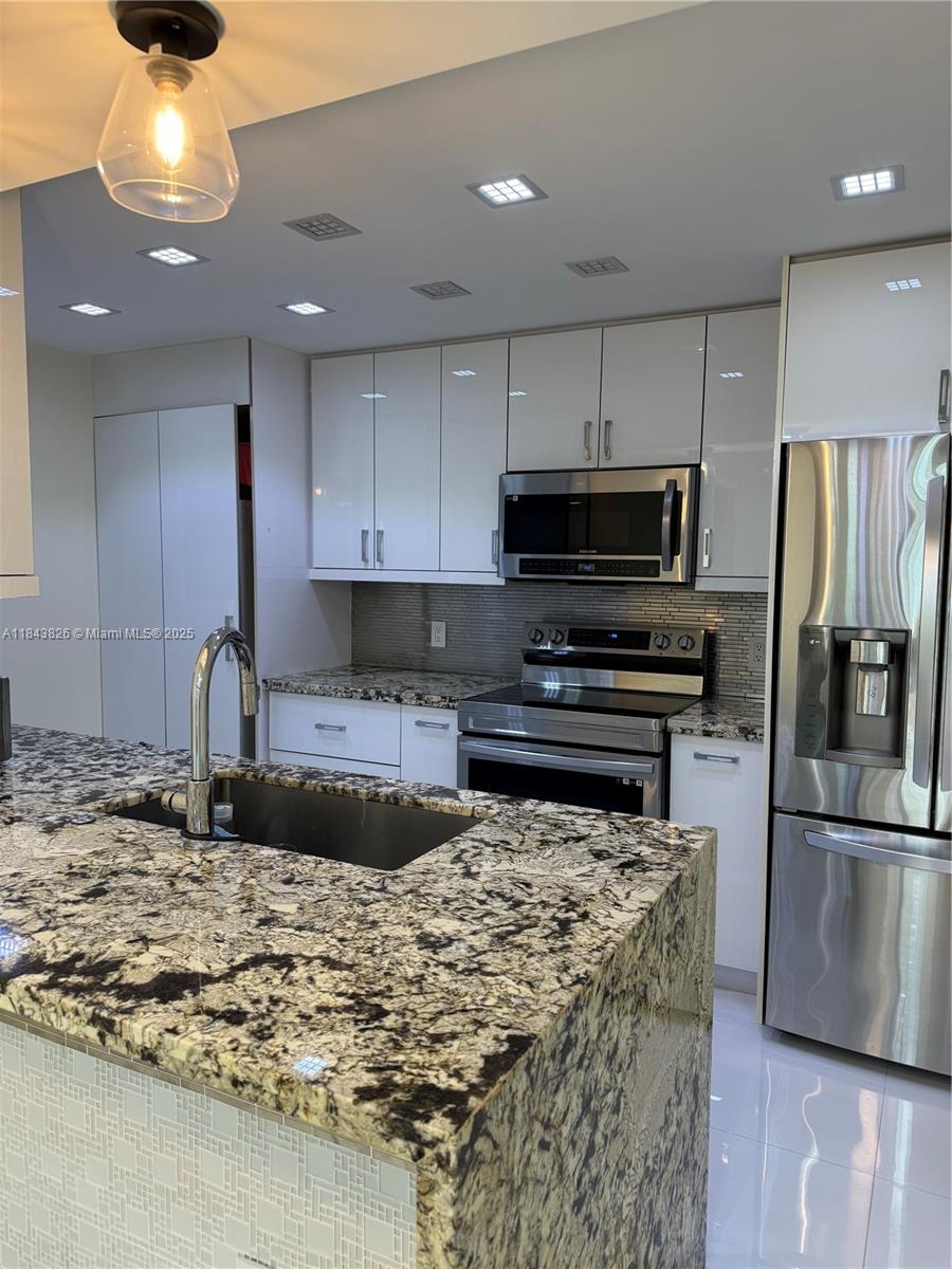 ABSOLUTELY GORGEOUS FIRST FLOOR CORNER UNIT, COMPLETELY FULLY RENOVATED WITH DECORATOR'S TOUCHES THROUH OUT. GRANITE COUNTER TOPS, STAINLESS STEEL APPLIANCES, EUROPEAN KITCHEN WITH LACQUER CABINETS, CALIFORNIA BUILD INS IN THE MAIN BEDROOM WALK IN CLOSET, SPLIT FLOOR PLAN, UPDATE RENOVATED BATHROOMS, WASHER AND DRYER INSIDE, HURRICANE IMPACT WINDOWS AND ASSIGNED PARKING SPOT IN FRONT OF UNIT. CONDO HAS ENCLOSED LARGE PATIO FOR YOU TO ENJOY YOUR MORNING COFFEE. COMPLEX HAS COMMUNITY POOL AND TWO TENNIS COURTS. NICELY MAINTAINED COMMUNITY OF WINDING LAKE AT WELLEBY IN THE CITY OF SUNRISE. CONVENIENTLY LOCATED CLOSE TO MAIN FREE WAYS, SHOPPING CENTERS, HOSPITALS, AND RESTAURANTS. HOA APPROVAL REQUIRED, PER HOA MINIMUM CREDIT SCORE REQUIREMENT IS 650.