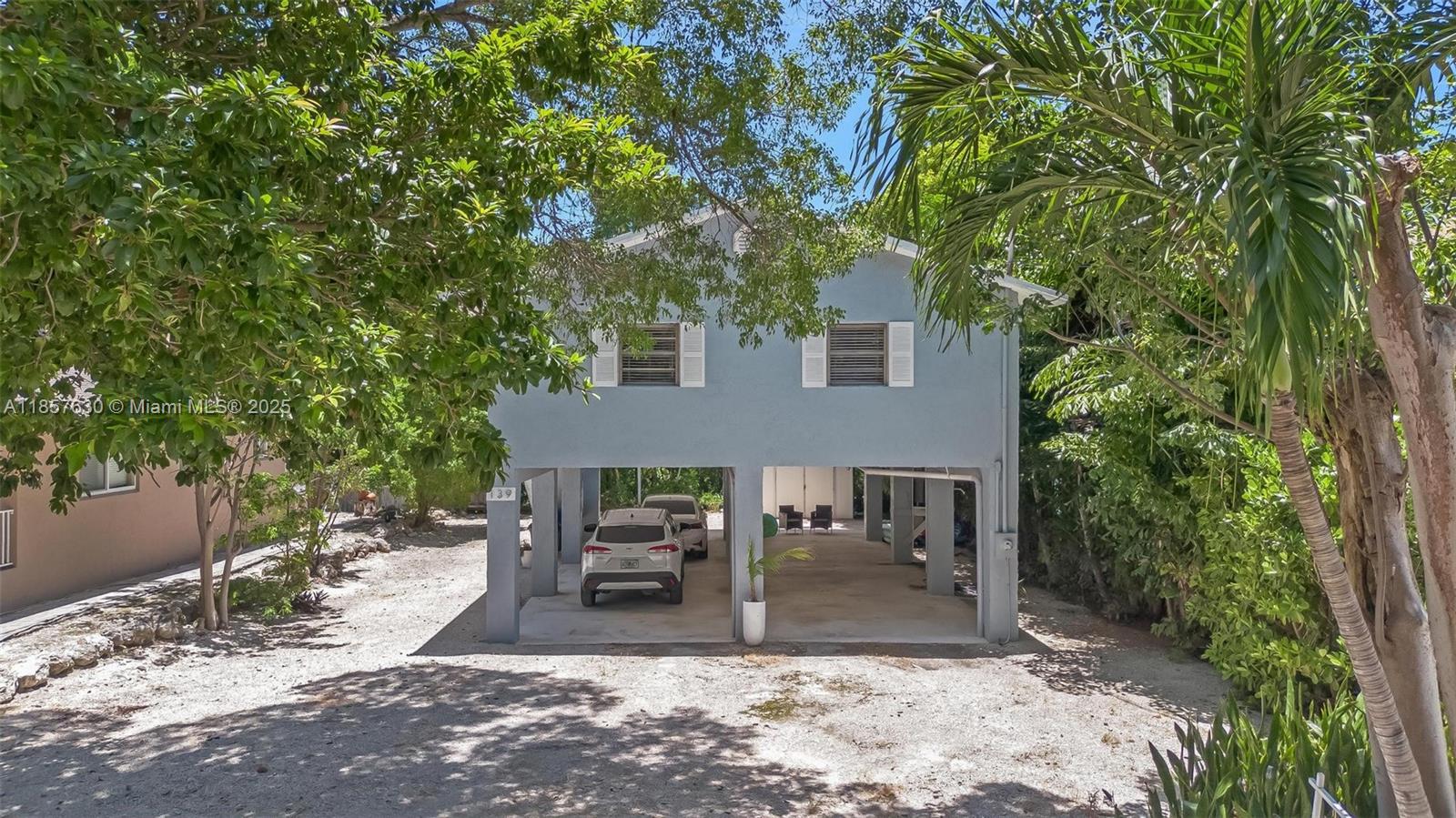 Welcome to this charming 3 BR / 2 BA elevated home just steps from the bay. This light-filled residence features vaulted ceilings, fresh interior paint, and a bright open layout ideal for coastal living. The updated kitchen boasts brand-new appliances, including refrigerator, oven with air-fryer mode, plus a full-size washer and dryer for convenience. Relax or entertain in the screened balcony, enjoy BBQs in the spacious yard, and store all your gear in the backyard shed. Located on a 5,000 sq ft lot in a peaceful bayside neighborhood, residents have access to a private beach, marina, tiki hut, picnic area, and boat ramp, just a minute walk away. Whether you’re seeking a full-time residence or vacation retreat, this home offers the perfect blend of comfort, style, and Key Largo charm.