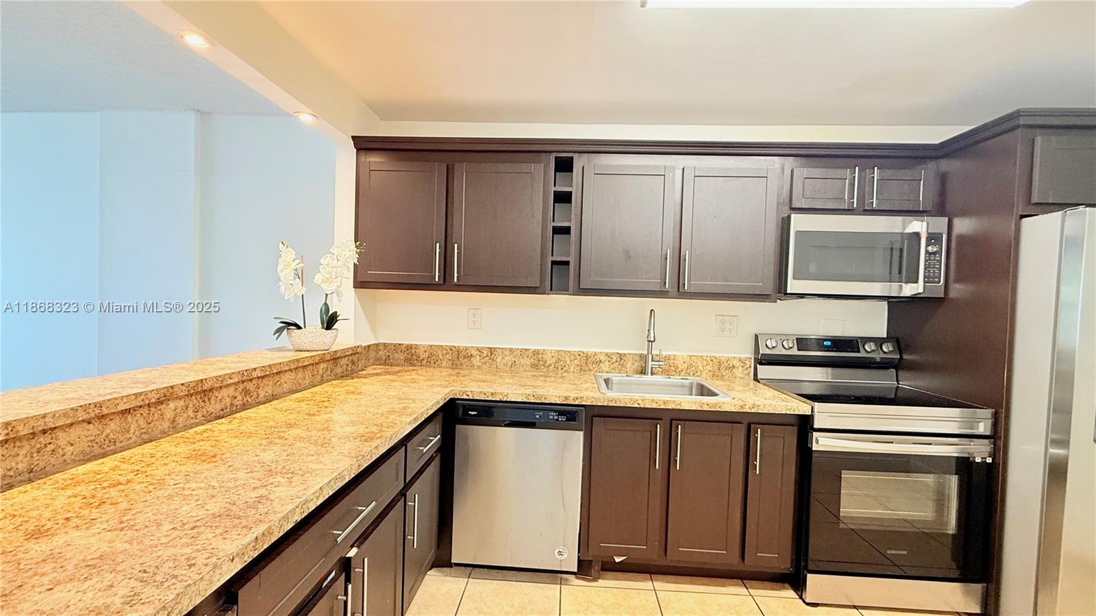 Beautiful 1-bedroom, 1.5-bathroom condo with a den, spanning 900 square feet. The unit is painted white and features dark laminate floors. It also includes a modern open kitchen with dark cabinets, countertops, and stainless steel appliances. The spacious bedroom comes with a walk-in closet, and the bathroom has a shower. The condo also includes 1 assigned parking space and a storage space outside the unit. Gated community with a pool. It is located near Biscayne Blvd, LA Fitness, the beaches, Whole Foods, banks, shopping centers, Aventura Mall, FIU, and Barry University. RENT INCLUDES: Water and Hot water. EASY TO SHOW