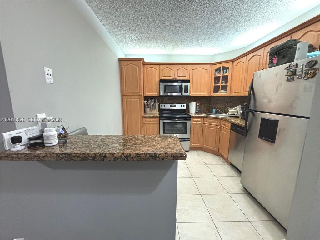 Photo of 3859 Coral Tree Cir #308, Coconut Creek, FL 33073 (MLS # A12010529)