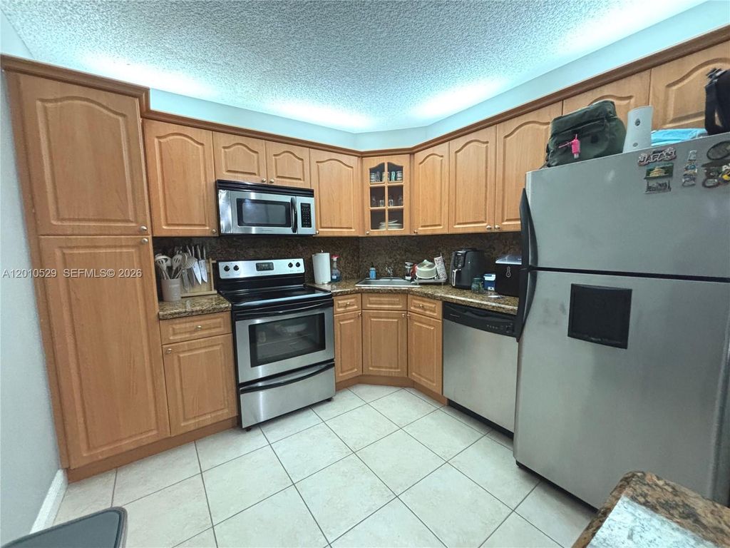 Photo of 3859 Coral Tree Cir #308, Coconut Creek, FL 33073 (MLS # A12010529)