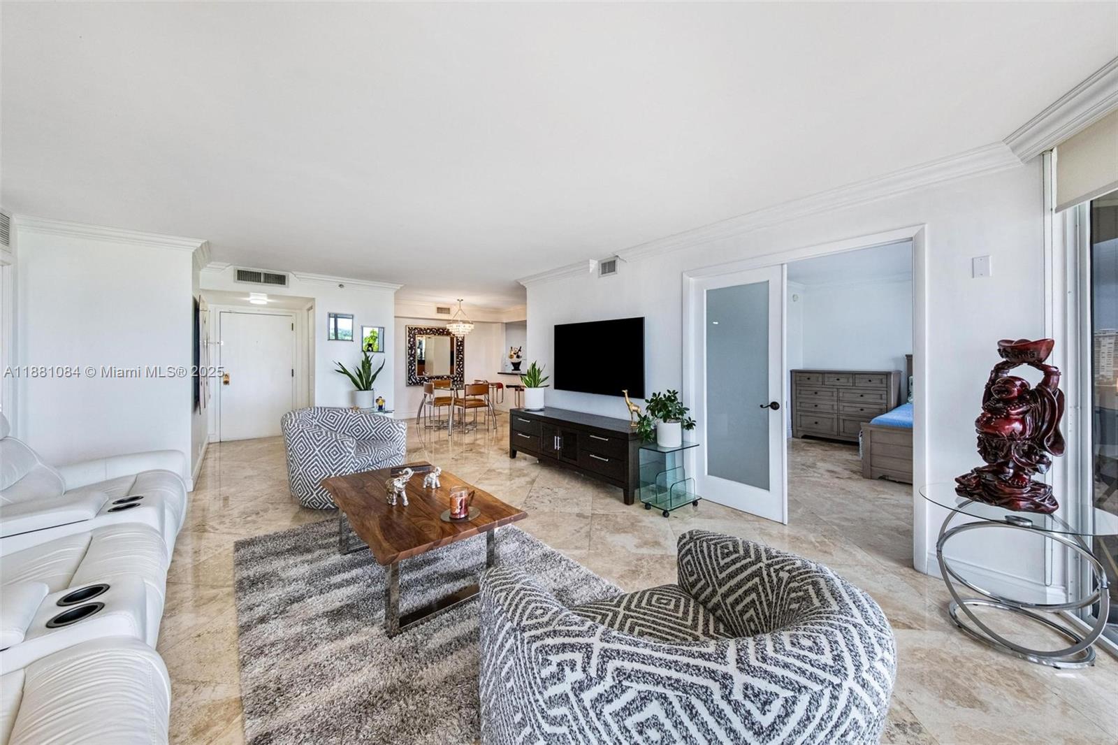 Step into this beautifully updated 2 bed/2 bath residence on the 12th floor and enjoy breathtaking panoramic views of Biscayne Bay, the Miami skyline, and lush tropical landscapes. The spacious balcony is perfect to relax, entertain, and soak in sunrise and sunset vistas. Inside, an expansive living and dining area is filled with natural light, featuring elegant marble floors and a modern open layout. The updated kitchen offers sleek granite countertops, warm wood cabinetry, stainless steel appliances, ample storage, new AC, and new garbage disposal. Located in a 34-acre resort-style gated community, The Towers of Quayside offers unmatched amenities: 8 tennis courts, pickleball, spa, fitness center, heated pools, marina, 24-hour security, on-site dining, and more.