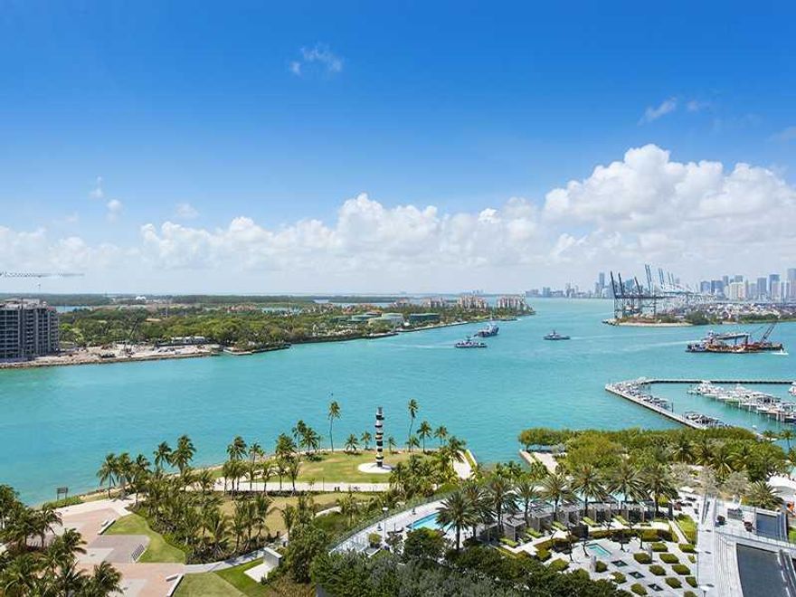 Wow-What a showpiece!  This stunning 3 bedroom has been beautifully designed and renovated to perfection, every inch of it.  Large glass tiles, wonderful wall treatments, great fixtures and lighting, new doors, custom closets, electric window treatments,  smart home iPad control, sound system. The kitchen and baths are gorgeous.  Incredible views of the Intracoastal, the city, the ocean and Miami Beach.  Large Sunrise and Sunset Terraces.  Two parking spots. Don't miss this opportunity!