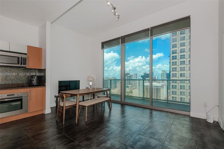 Breathtaking city skyline and partial bay views from this highly coveted penthouse in the sought-after “03” line. This 1-bedroom, 1-bath residence features impressive 11.4 ft volume ceilings, North exposure, and sleek tile flooring throughout. Italian cabinetry, granite countertops, and stainless steel appliances. Cable and Internet included. One assigned parking space. Ideally located in the heart of downtown, just steps from Whole Foods, Bayfront Park, Metromover, Novikov, Joe & The Juice (in the building), and Silverspot Cinema. Full-service building with 24-hour attended lobby. Unit is currently rented to excellent tenants through 03/14/2027—ideal for investors seeking immediate income. Elevated urban living at its finest. Pool is presently closed for repairs, opening soon.