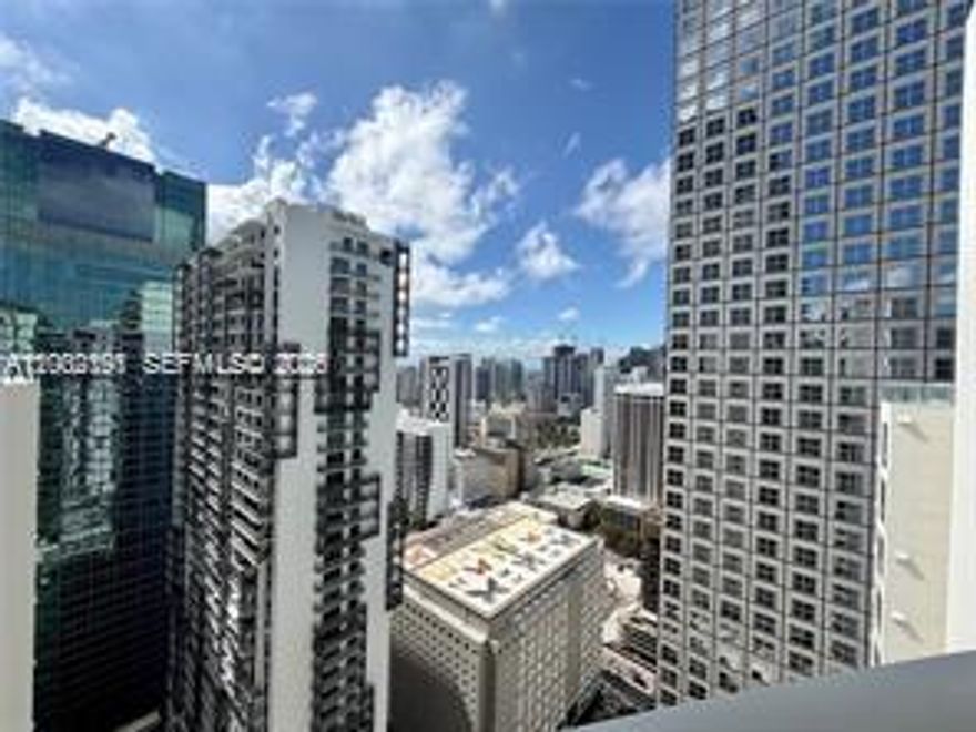 Breathtaking city skyline and partial bay views from this highly coveted penthouse in the sought-after “03” line. This 1-bedroom, 1-bath residence features impressive 11.4 ft volume ceilings, North exposure, and sleek tile flooring throughout. Italian cabinetry, granite countertops, and stainless steel appliances. Cable and Internet included. One assigned parking space. Ideally located in the heart of downtown, just steps from Whole Foods, Bayfront Park, Metromover, Novikov, Joe & The Juice (in the building), and Silverspot Cinema. Full-service building with 24-hour attended lobby. Unit is currently rented to excellent tenants through 03/14/2027—ideal for investors seeking immediate income. Elevated urban living at its finest. Pool is presently closed for repairs, opening soon.