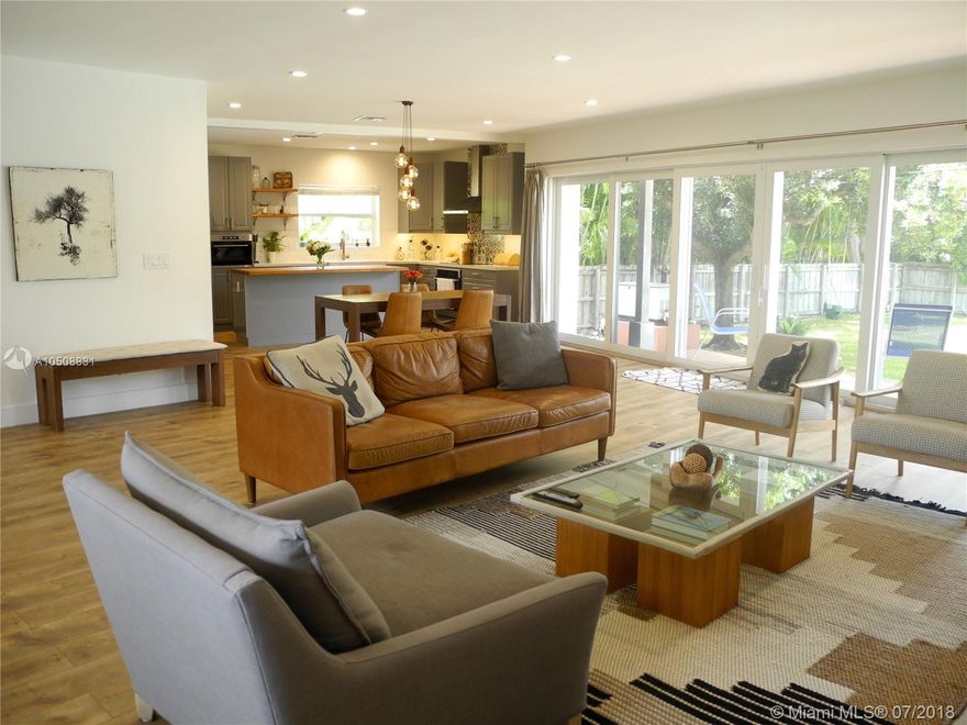 One-of-a kind, dream layout of a house, gutted and tastefully remodeled in 2017 with brand new kitchen, 3 full baths (along with plumbing) electrical, impact windows and doors. Amazing open-design main room that flows from living room into kitchen, perfect for entertaining. Beautiful wide-plank oak flooring throughout, Marca Corona terra-cotta tile design unique in each bathroom and New Mexico tiles as kitchen centerpiece. Custom oak kitchen island top, farmhouse sink, huge cupboards for storage. Gorgeous stacking wall-to-wall sliding door system, with breathtaking 13’ opening making indoor/outdoor feel like 1 space. Brand new deck steps down to 28’ pool alongside huge yard and gorgeous Japanese Blueberry tree. Cool breezes across the street from water in coveted east end of Miami Shores.