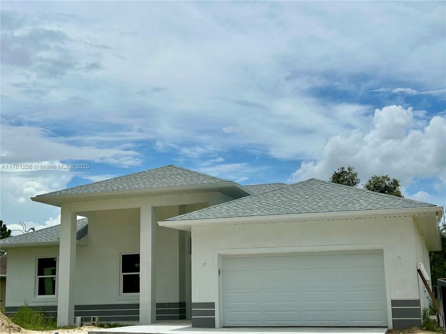 Stunning new construction oversized 3 bed/2 bath home in Lehigh Acres! Modern open floor plan with soaring ceilings, gourmet kitchen featuring stainless steel appliances, quartz countertops, and a large island. Oversized master suite with luxurious bath, dual sinks, and walk-in shower. Energy-efficient features, impact windows, and 2-car garage. Spacious lot, no HOA, no flood zone. Perfect blend of luxury and convenience, close to schools, shopping, and highways. Schedule your tour today!
