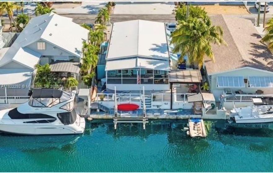 Waterfront 3BR/2BA manufactured home with direct ocean access in the Florida Keys! Located on a 40-ft deep canal just minutes to the bay, this property features a 14,000 lb boat lift and 40 ft of waterfrontage perfect for boating, fishing, diving, or sandbaring—bright, open concept living space with natural light throughout the kitchen, dining, and living areas. Close to Harry Harris Park, which offers a boat ramp for use if you live in the community, Ideal as a full-time residence or weekend getaway. Not using it full-time? Rent it out to snowbirds or visitors seeking the Florida Keys lifestyle. Don’t miss this boater’s paradise!
