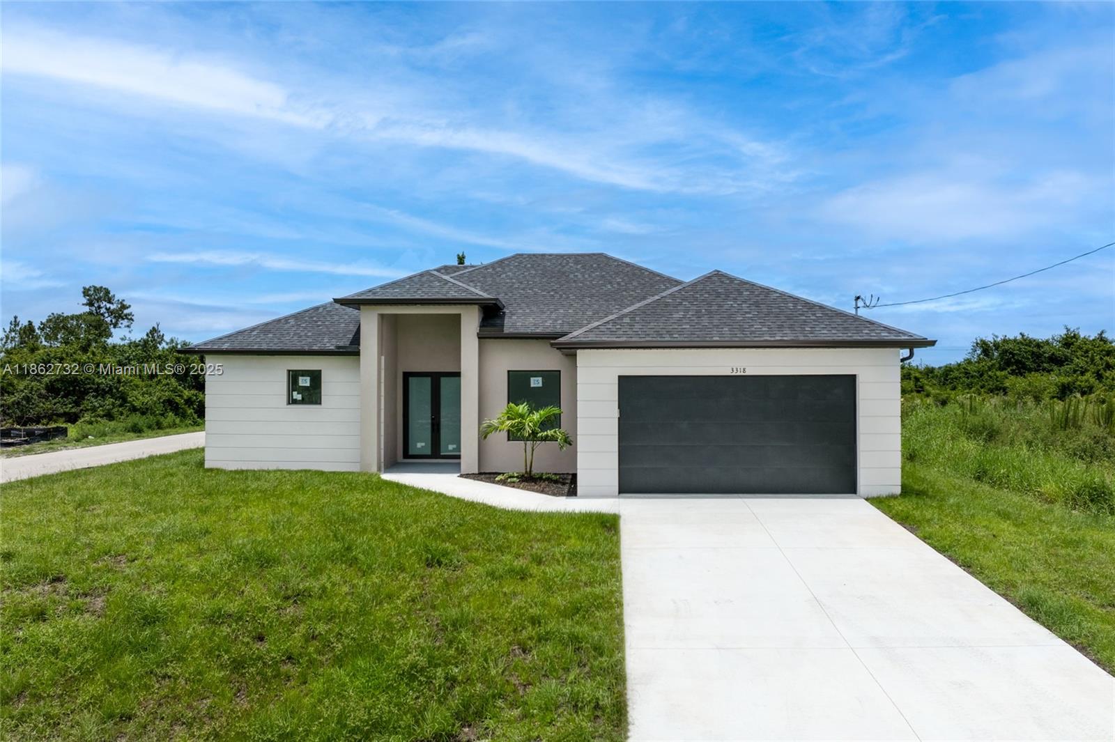 Discover this beautiful new contemporary 3 beds + den, 2.5 baths home on a prime corner lot in Lehigh Acres, Florida. Enjoy quartz countertops, porcelain floors, stainless steel appliances, and a stunning Chef's kitchen. The versatile den can be a 4th bedroom or office. Features include a guest bath with outdoor access, in-house laundry and a large driveway/walkway. Close to shops and dining — schedule your tour today!