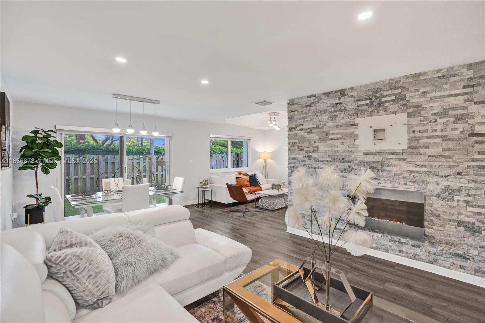 Tucked inside a gated community with freshly cleaned roofs and 24-hour security, this beautifully updated home offers peace of mind in the safe and vibrant city of Doral—one of the most desirable places to live in South Florida. Featuring 3 BD | 2.5 BA, a sleek recycled kitchen with stainless steel appliances, and a bright living room with stone-accented walls and an electric fireplace. Enjoy impact windows throughout with privacy under your zebra blinds. A private backyard with synthetic grass, and no rear neighbors. HOA includes cable and internet. Residents enjoy a clubhouse, pool, playground, and proximity to top-rated schools, shopping, and entertainment—all just minutes from major highways.
