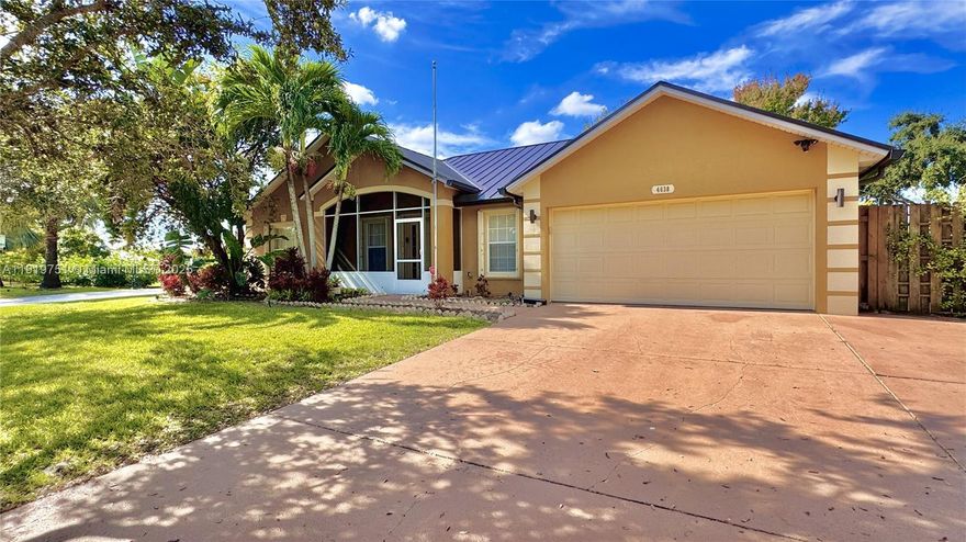 A rare find! 3/2/2cg CBS home on a fully fenced .46 acre double lot with water views and lush landscaping - ideal for those who want to relax in nature in their own private oasis while also enjoying quick access to Tradition and interstate roadways. This home has been meticulously maintained and upgraded: new roof (2024), newer A/C (2022) & appliances, and the irrigation system is on its own well water source. The second driveway and covered carport is perfect for your boat, camper or work vehicle. The rear of the home boasts a 20X20 custom tiled patio & screened porch. There is an additional 288 sqft workshop/shed with electricity & a garage door. The home is equipped with accordion hurricane shutters on all doors & windows. No neighbors to the South & no HOA. This is a must see home!