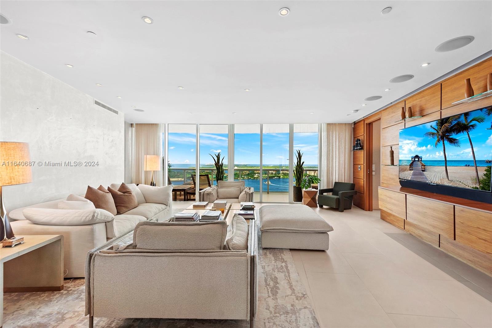 This rarely available 04-line flow-through residence offers stunning sunrise and sunset views, an open floor plan, and in-wall speakers in every room. The living area features intricate millwork and two elegant sitting areas, perfect for entertaining. The master suite includes a rain shower with jets and an in-wall mirror TV in the bathroom. Located in the sought-after South of Fifth neighborhood, this 3,000 sq. ft. home showcases floor-to-ceiling glass windows, Sub-Zero and Miele appliances, and breathtaking views of the ocean, bay, and city. Murano Grande offers luxury amenities, including a full-service pool, lighted tennis court, 24-hour valet, and concierge services, all within walking distance to South Pointe Park and top restaurants.