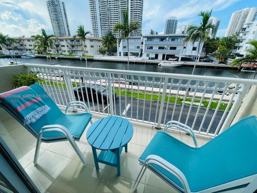 Beautifully renovated 1 bedroom + office, 1.5 bath waterfront condo in the exclusive, 24/7 police-guard-gated Eastern Shores community. This bright and open unit offers direct water views from both the living room and bedroom, creating a peaceful coastal atmosphere. Tile floors run throughout, and the open kitchen features wood cabinetry, granite countertops, and stainless-steel appliance. The spacious primary suite includes a walk-in closet and an updated bathroom, plus an additional half bath for guests. Enjoy the breeze from your private balcony overlooking the canal. The building provides assigned parking, guest parking, common laundry, elevator access, and well-maintained amenities. Boaters will appreciate ocean access with no fixed bridges and the option to rent a boat slip (waitlist). The location is unbeatable—walk to shopping, dining, movies, and you're just minutes from Sunny Isles Beach and Haulover.