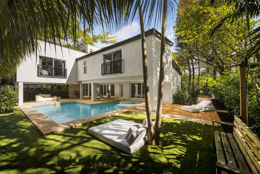 Thoughtfully remodeled mid-century residence on a prominent corner lot in South Coconut Grove, just minutes to top-rated public and private schools, parks, marinas, and the village. Gated, this 4BD/4BA home offers a split-bedroom layout with 2 bedrooms on the main level and 2 upstairs with ensuite baths. New metal roof (2025) and full impact glass complement large-format wide plank European oak floors throughout. Light-filled living spaces seamlessly extend to a spacious covered terrace designed for effortless indoor-outdoor living, perfect for al fresco dining and entertaining. Enjoy a private backyard with pool and spa, lush canopy and fruit trees—capturing the essence of Coconut Grove living—along with a rooftop retreat and timeless coral rock detailing throughout the interior and exterior.