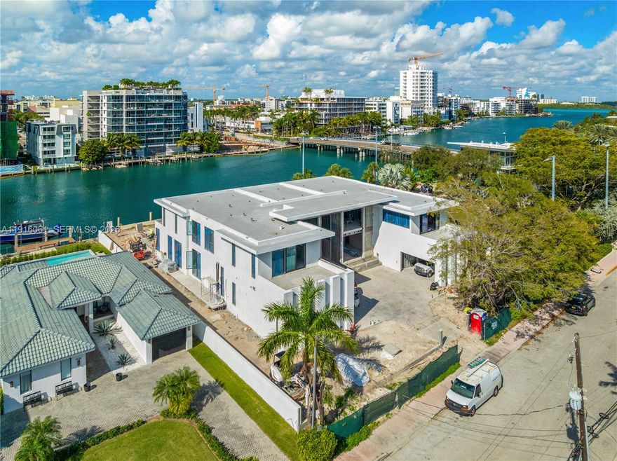 This nearly completed modern estate by Kobi Karp offers 13,060 SF of stunning architecture, gleaming sunsets, and seamless indoor-outdoor living. Designed as a private resort on a rare 22,750 SF double lot in walkable Surfside, with 125’ of intracoastal waterfront, this 7-bed, 9.5 bath residence features a showstopping great room, first floor junior primary suite, Italian millwork and exquisite marble throughout, home gym with sauna/steam, office, cabana, pajama lounge, and home theater. Towering glass walls fade into the horizon, framing wide-bay views with plentiful natural light. A breathtaking infinity pool, spa, and yacht-ready dock overlooking the wide waterway make this the ultimate waterfront retreat.